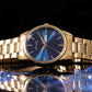 Sonata Quartz Analog with Day and Date Blue Dial Golden Stainless Steel Strap Watch For Men 77147ym01